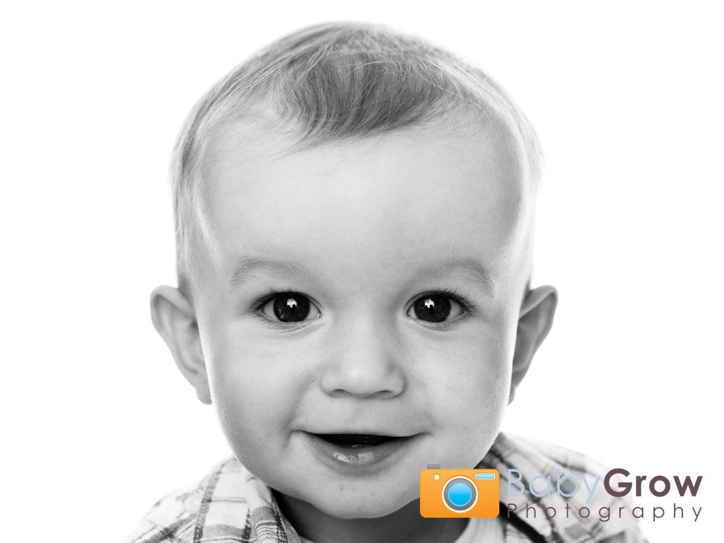 Smiling baby headshot on white background
