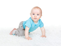 Cheeky crawling baby on white background