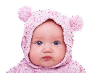 Cute baby girl in pink knitted hoodie